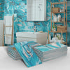 Stacks of blue and white marble self-adhesive wall stickers displayed against a teal marbled background with wooden shelving.
