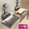 A stainless steel wall-mounted soap dish with a drain and a suction cup dispenser is shown on a light-colored wall.