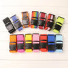 A collection of colorful adjustable polyester luggage straps arranged in a row.