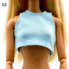 A fashion doll wearing a light blue, cropped, ribbed top.