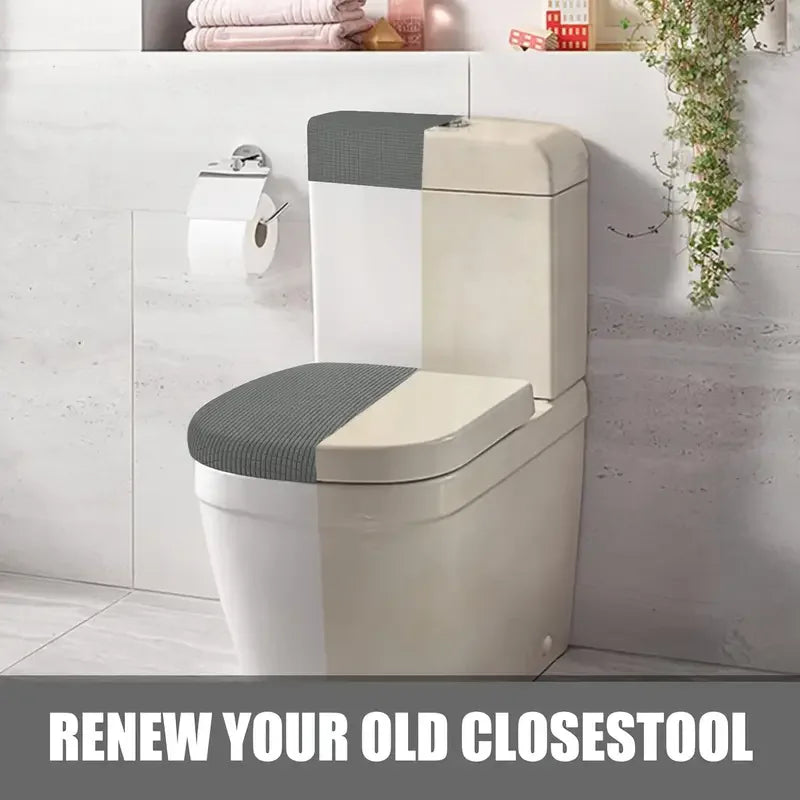 A modern white toilet with a gray seat cover and matching lid and tank covers mounted on a wall.