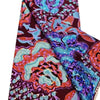 A close-up view of a vibrant pink glitter African wax print fabric with intricate floral patterns.