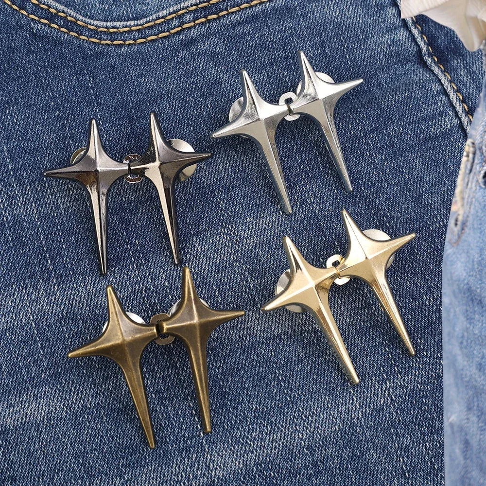 A set of four silver and gold Y2K star-shaped clips used as waist tighteners for jeans.