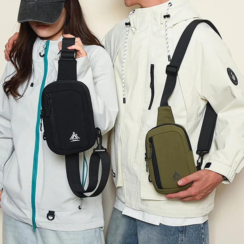 A woman is holding a water-resistant nylon chest sling bag in olive green and black against a white jacket.
