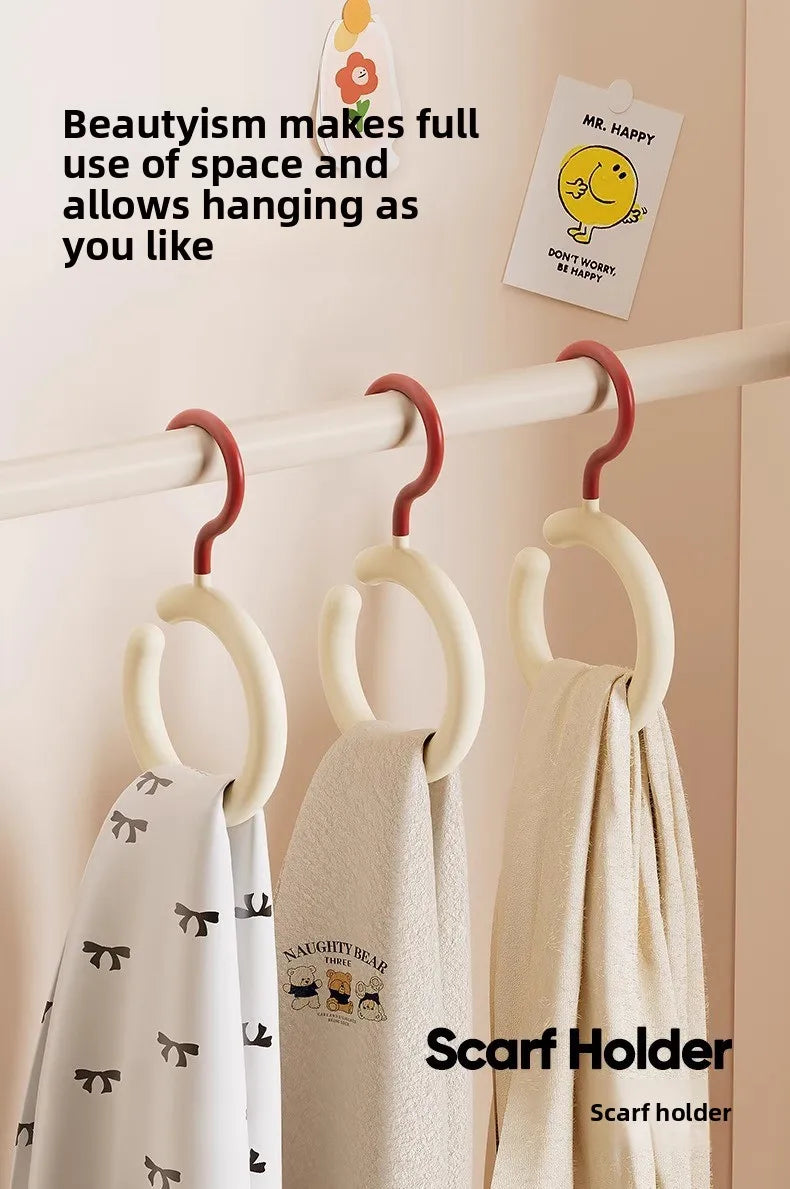 A white scarf hanger is displayed on a wooden rack, showing how to hang a scarf.