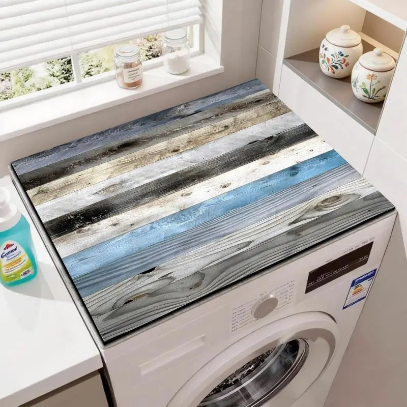 A close-up of a wood grain waterproof washer and dryer mat installed inside a white washing machine.