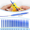 A hand holds a yellow knitted item with blue and yellow knitting needles and a separate blue needle.
