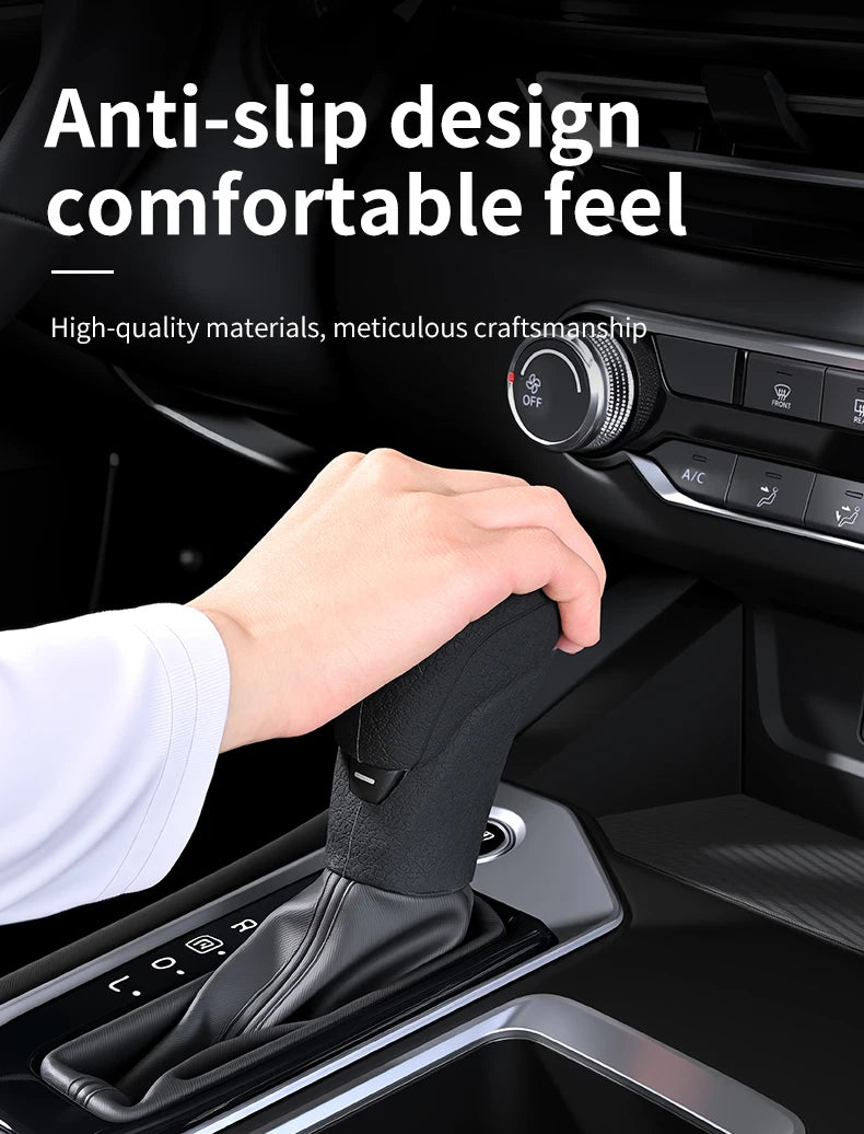 A hand is shown placing a black silicone gear shift cover onto a vehicle's transmission.