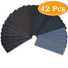 A fan of 42 pieces of wet and dry sandpaper assorted grits displayed in a fan shape.