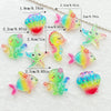 A collection of colorful, iridescent resin charms shaped like sea creatures and shells for crafting.