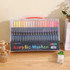 A box of Acrylic Markers with 32 colors displayed on a wooden table.