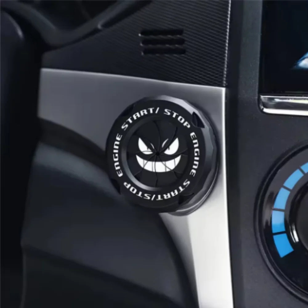 Close-up of a black rotating protective cover for a car ignition start button with Engine Start/Stop markings.