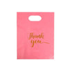 A pink gift bag with a handle, featuring the text Thank you written in gold script.
