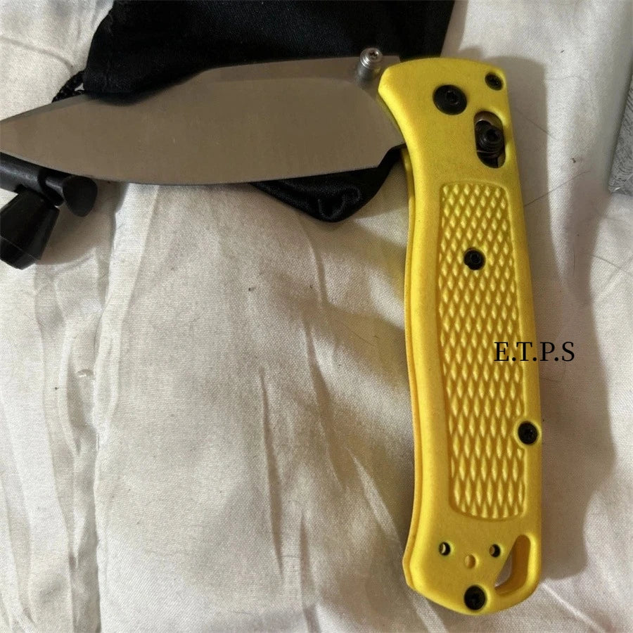 A yellow folding pocket knife with a drop point blade is shown against a white background.