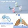 A set of silicone hanger stacking hooks in various colors demonstrating space-saving wardrobe organization.