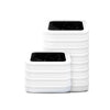 A stack of white replacement refill rings for smart kitchen trash cans.