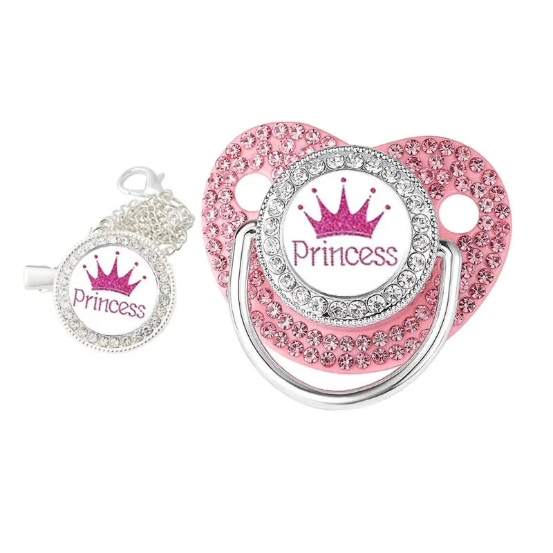 A set of pink and silver crystal rhinestone pacifier chain clips with silicone nipples.