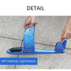 A hand is holding a blue foam glider plane with a light texture, demonstrating the material detail.