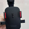 A black universal gravity car phone holder with a hook clip is held in a hand.