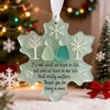 A handcrafted sea glass Christmas ornament shaped like a snowflake, featuring a quote about what truly matters.