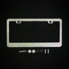 A rectangular crystal rhinestone license plate frame with mounting tabs and small hardware components.