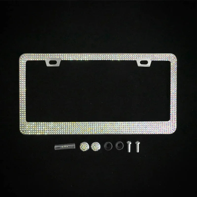 A rectangular crystal rhinestone license plate frame with mounting tabs and small hardware components.