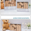 A presentation of a wooden train track expansion package with various pieces and a teddy bear.