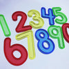 A colorful set of transparent plastic numbers 2 through 9, used for counting and Montessori math learning.