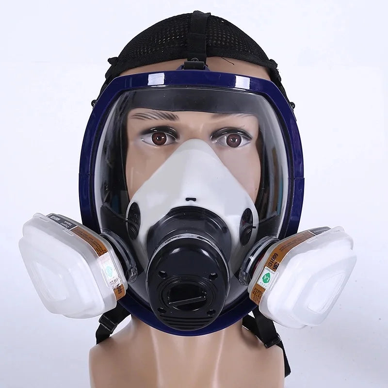 A full face respirator mask with a clear visor and white filter cartridge displayed on a mannequin head.