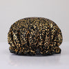 A black fabric shower cap with a leopard print pattern and gold accents.