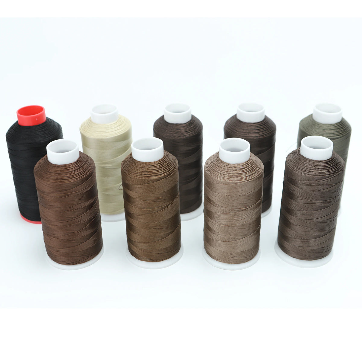 A collection of spools of heavy-duty nylon bonded thread in various shades of brown and olive green.