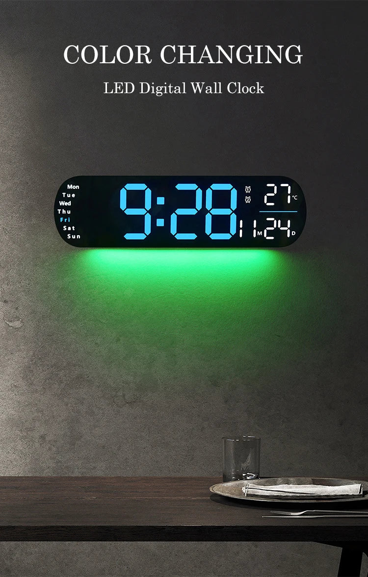 A digital wall clock displaying 9:28 with an RGB color changing feature mounted on a gray wall.