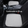 A gray ergonomic car seat cushion is shown placed in the interior of a car, demonstrating its fit and comfort.