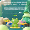 A green frog balance game toy demonstrating pointer deflection and weight distribution for learning.