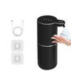 A black touchless automatic soap dispenser is shown with a hand dispensing soap.