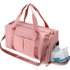 A pink duffel bag with shoulder straps and a shoe compartment is shown.