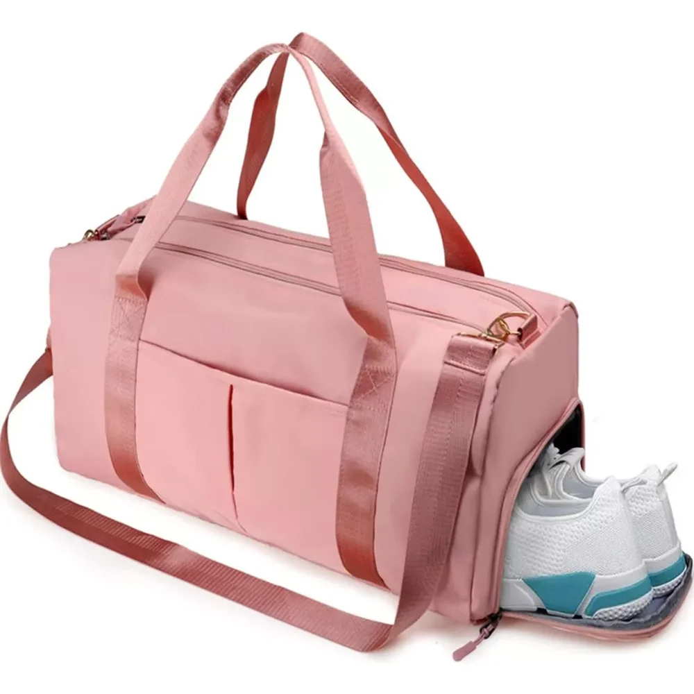 A pink duffel bag with shoulder straps and a shoe compartment is shown.