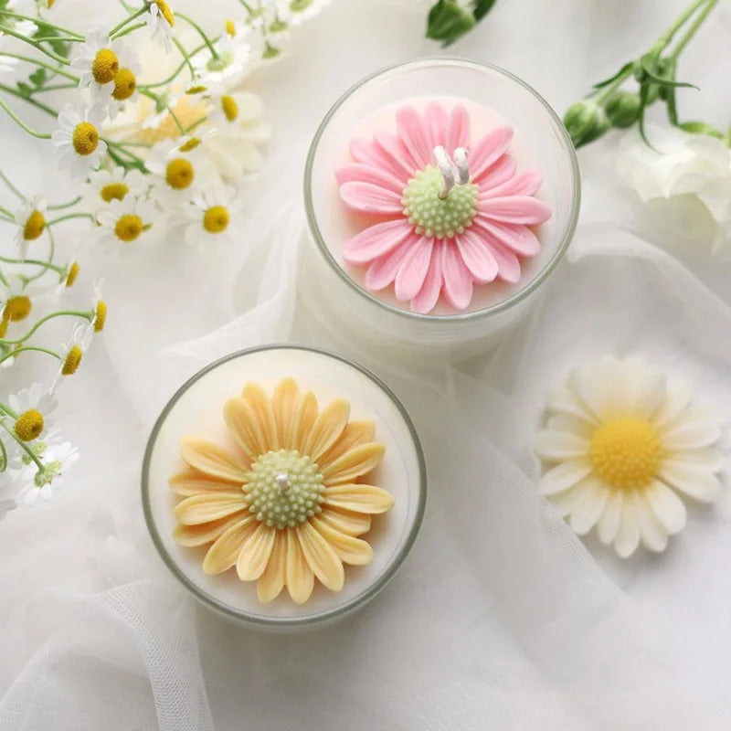 Two glass jars display pink and yellow daisy silicone molds for crafting