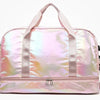 A pink iridescent travel duffel bag with light pink straps and a silver zipper.