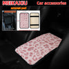 A leopard print plush armrest pad set for car accessories shown in a black car interior.