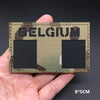 A close-up of a Belgium national flag tactical patch with hook-and-loop backing and camouflage pattern.
