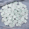 A pile of light mint green embroidered star-shaped iron-on patches for DIY clothing decoration