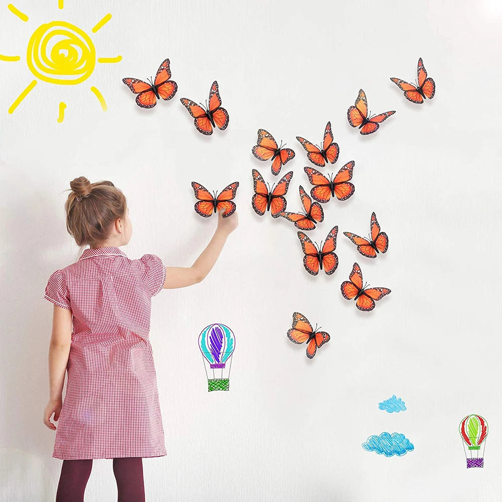 A child is placing monarch butterfly magnets on a white wall under a bright yellow sun.