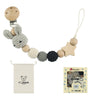A wooden pacifier clip chain made of crochet beads in natural wood and gray colors, with a small pouch and card.