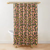 A shower curtain featuring a leopard print pattern in shades of orange, green, and black.