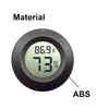 A black circular device made of ABS material displaying a temperature of 86.9°F and 73% humidity.