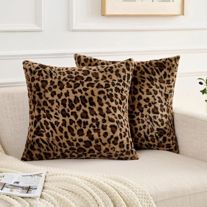 A close-up of a brown leopard print velvet pillow resting on a light sofa.