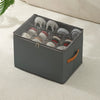 A gray foldable shoe organizer with a dustproof lid is shown open, containing various pairs of shoes on a white textured surf