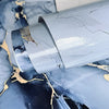 Close-up of blue marble self-adhesive PVC wallpaper showing texture and cracks on a surface.