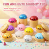 A collection of colorful squishy toys in various shapes and colors displayed on a light wooden surface.